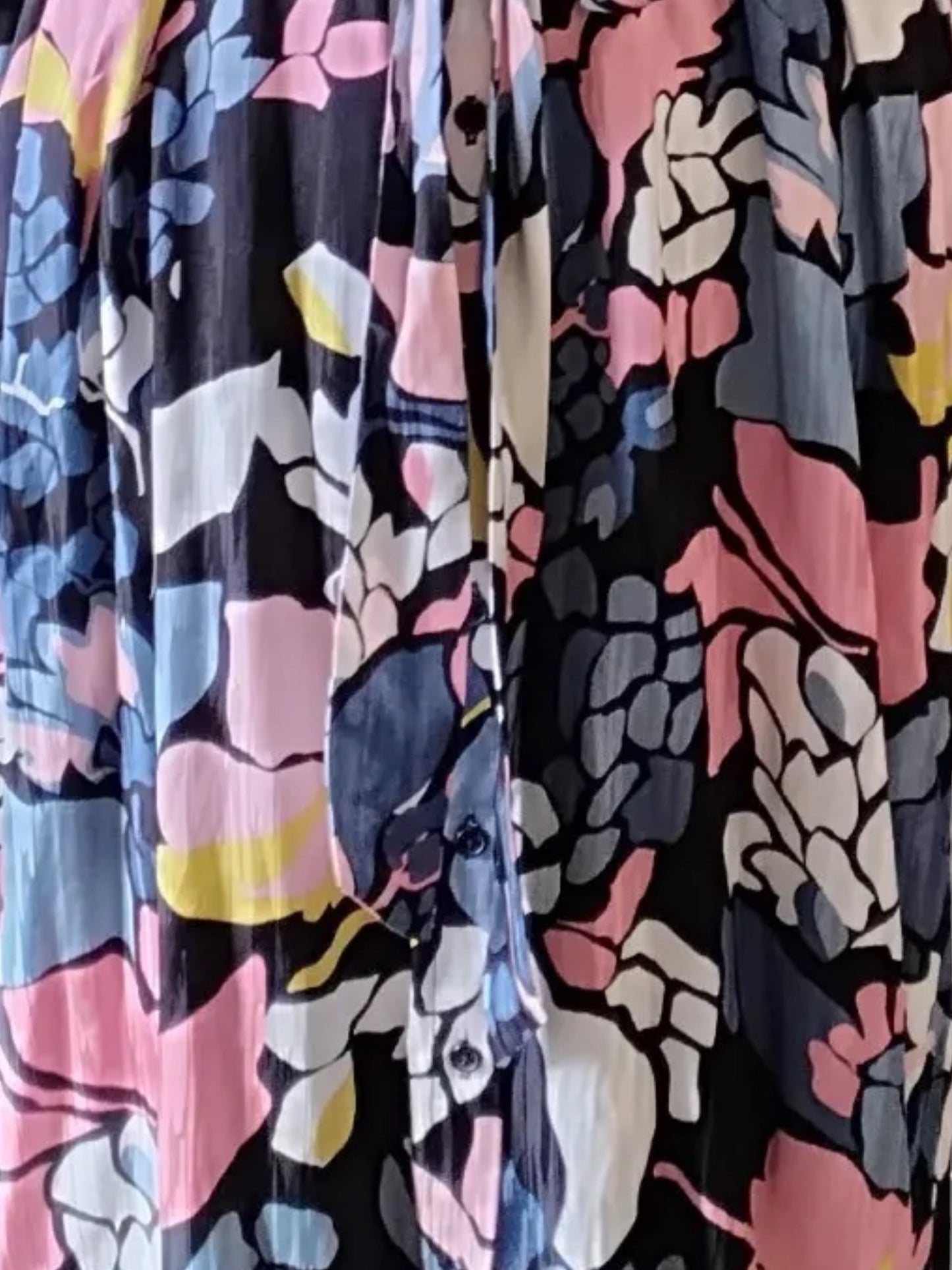 Circular Dress Collaborative long sleeve button front dress with a vibrant floral print in blue, pink, yellow, and white on black.