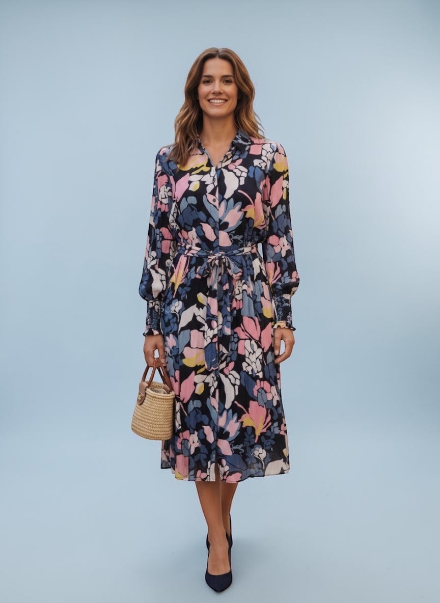 Circular Dress Collaborative long sleeve floral print midi dress with tie waist and button front in blue, pink, yellow, and white.